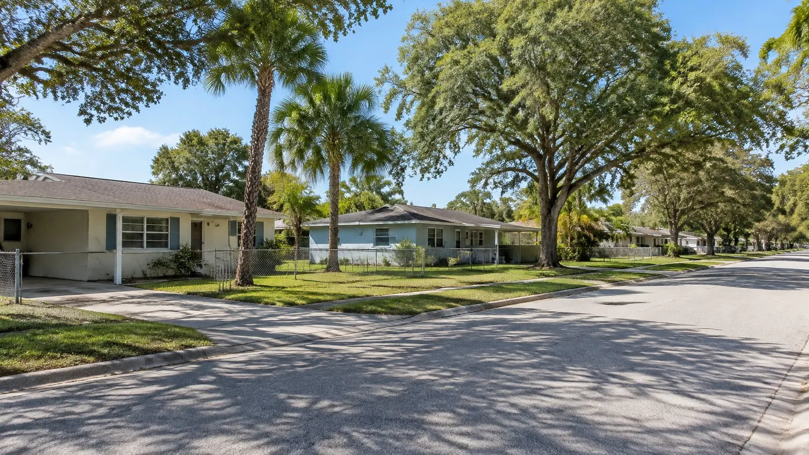 Single-story concrete-block ranch homes with low shingle roofs and carports on a Largo street